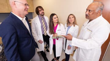 Sam Sears, left, director of ECU’s clinical health psychology program, discusses the field of cardiac psychology with doctoral students Zachary Force, Scarlett Anthony and Elizabeth Jordan, as well as Raj Nekkanti, right, director of ECU’s cardiac fellowship program.