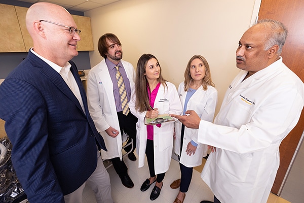 Sam Sears, left, director of ECU’s clinical health psychology program, discusses the field of cardiac psychology with doctoral students Zachary Force, Scarlett Anthony and Elizabeth Jordan, as well as Raj Nekkanti, right, director of ECU’s cardiac fellowship program.