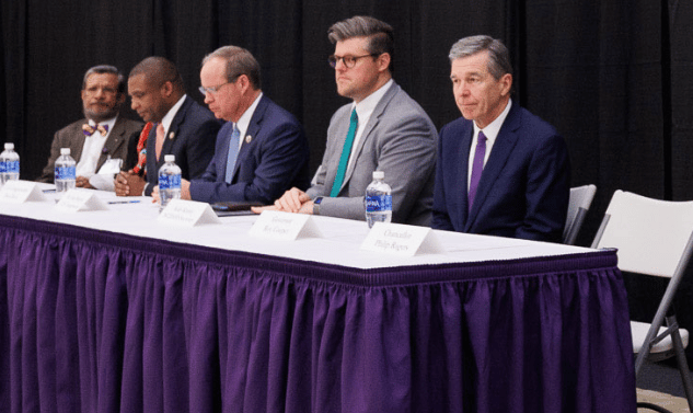 North Carolina Governor Roy Cooper sits on a panel with other officials and Dr. Sy Saeed.