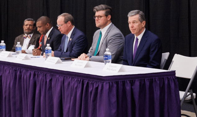 Cooper Visit North Carolina Governor Roy Cooper sits on a panel with other officials and Dr. Sy Saeed.