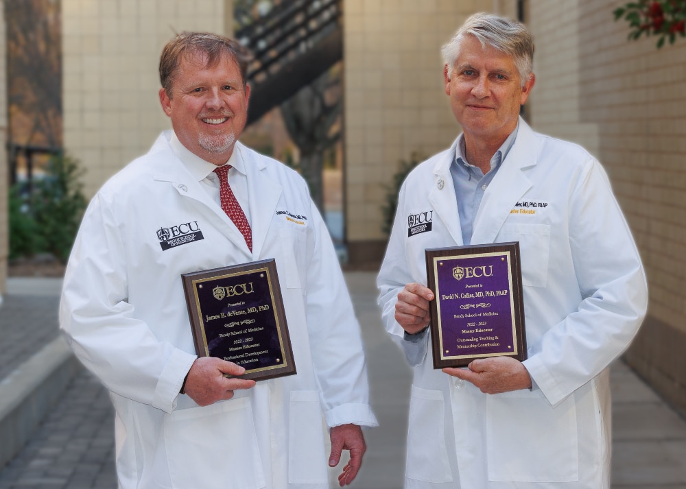 Drs. David Collier and James deVente pose for a photo after they were recently named master educators by the Brody School of Medicine at East Carolina University.
