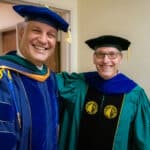 ECU Health Chief Health Officer Dr. Jason Higginson poses for a photo with ECU Health CEO Dr. Michael Waldrum at the Brody School of Medicine graduation.