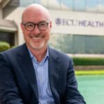 ECU Health Chief Operating Officer and President of ECU Health Medical Center Brian Floyd poses for a photo outside of ECU Health's Administration Building.