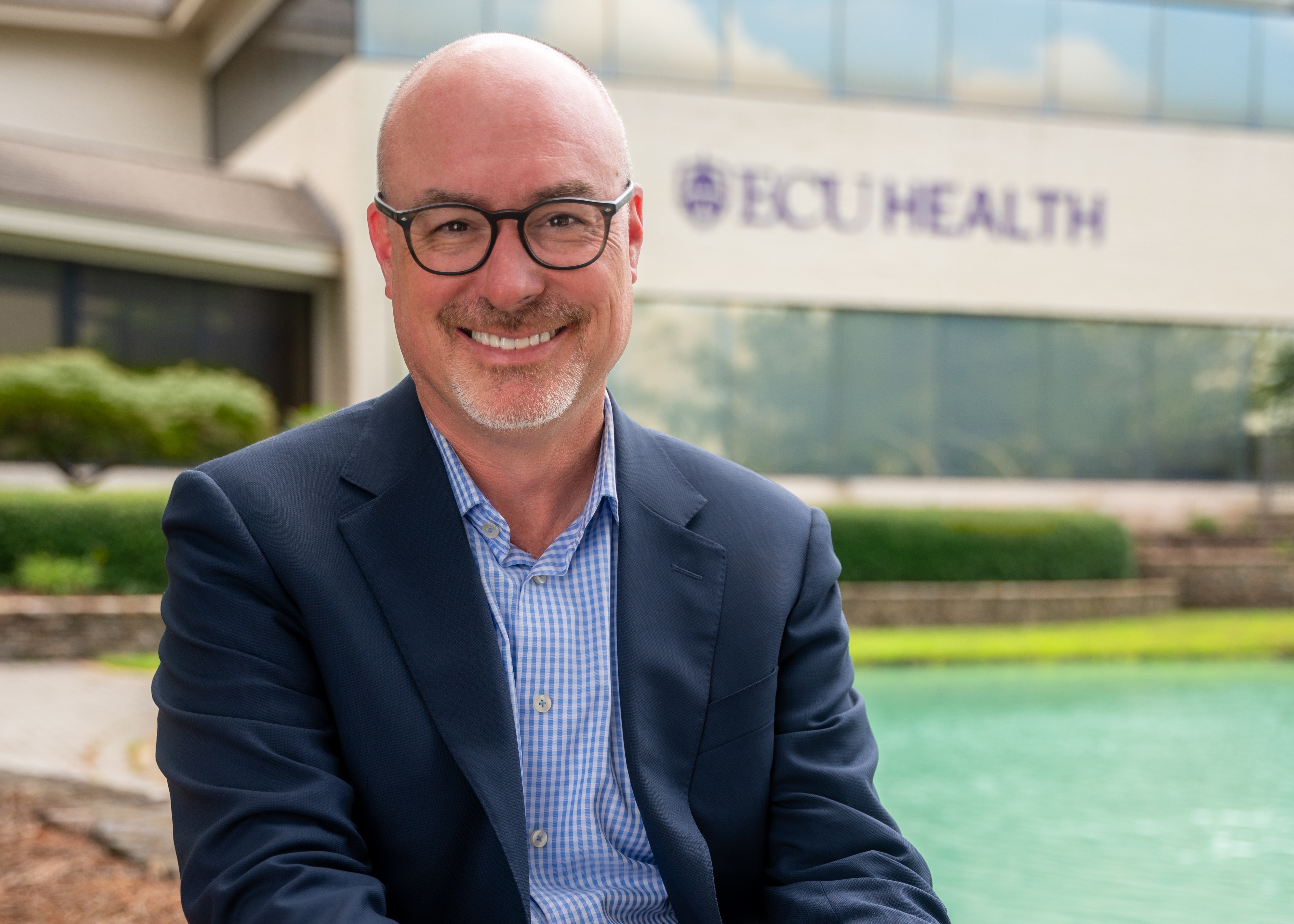 ECU Health Chief Operating Officer and President of ECU Health Medical Center Brian Floyd poses for a photo outside of ECU Health's Administration Building.