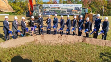 From left: Brennen Reynolds, Jeffrey Woods, Dr. Sy Saeed, Isa Diaz, Dr. Michael Genovese, Chris Hunter, Sec. Kody H. Kinsley, Dr. Michael Waldrum, Brian Floyd, Todd Hickey, Bob Greczyn, Dr. Michael Lang, Chancellor Philip Rogers, William Monk hold shovels during the groundbreaking for the upcoming behavioral health hospital in Greenville.