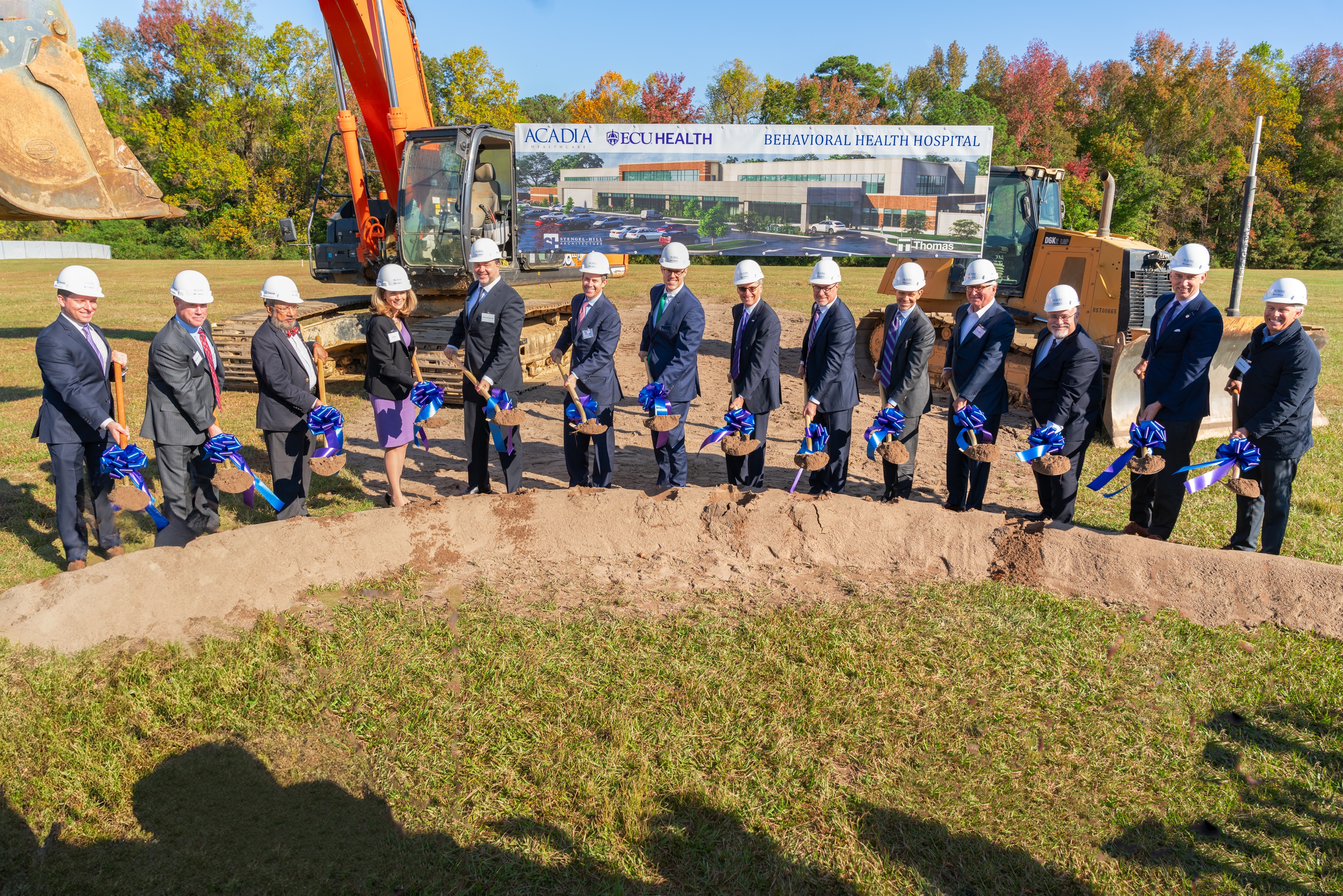 From left: Brennen Reynolds, Jeffrey Woods, Dr. Sy Saeed, Isa Diaz, Dr. Michael Genovese, Chris Hunter, Sec. Kody H. Kinsley, Dr. Michael Waldrum, Brian Floyd, Todd Hickey, Bob Greczyn, Dr. Michael Lang, Chancellor Philip Rogers, William Monk hold shovels during the groundbreaking for the upcoming behavioral health hospital in Greenville.