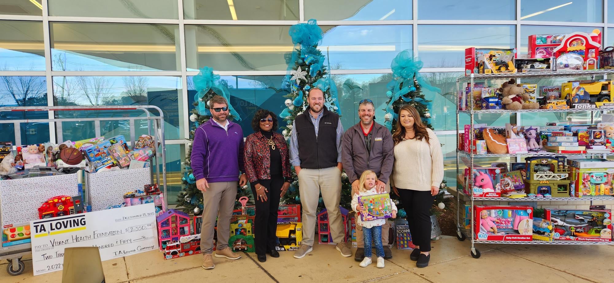 TA-Loving-Donation-1 A team of TA Loving representatives stand outside of Maynard Children's Hospital at ECU Health Medical Center with a holiday donation for the children at the hospital.