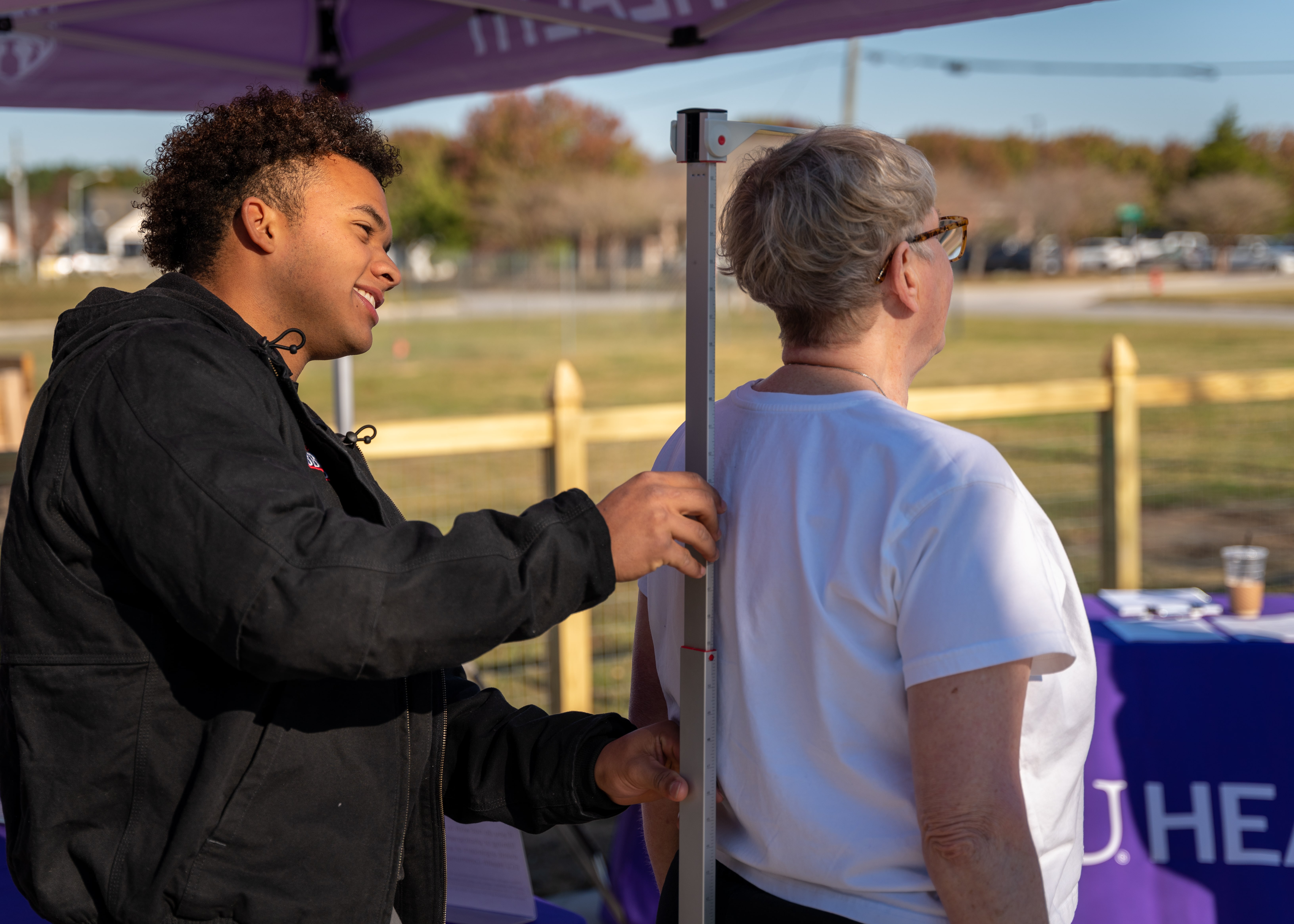 A community member takes part in a wellness screening at a community health event.