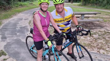 Tony and Delia Parker pose for a photo during a bike ride in Greenville. Tony survived a cardiac arrest during a road race in Greenville in 2021.