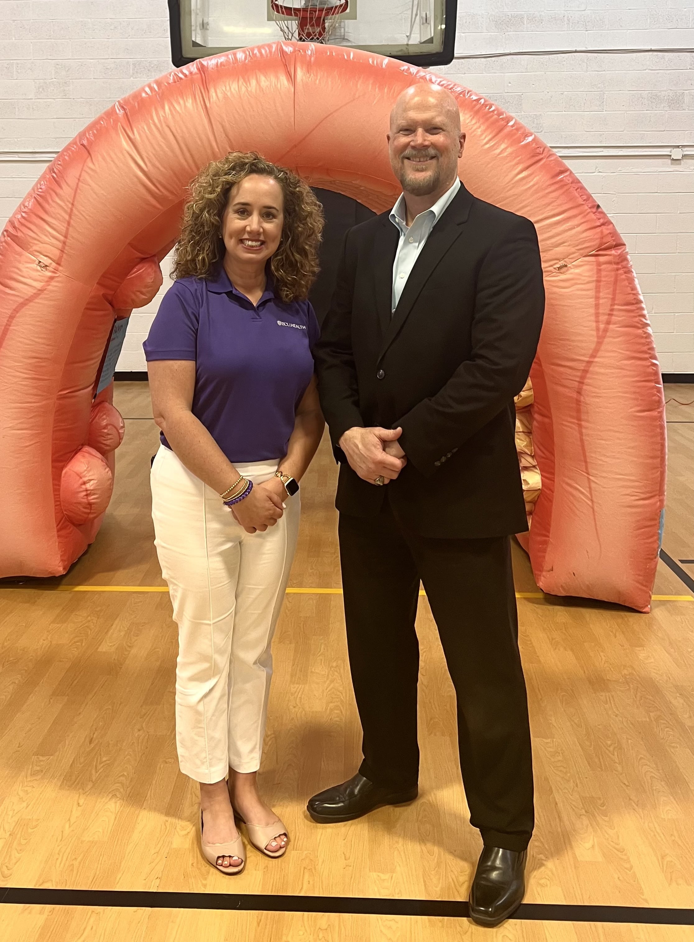 Stephen Braddy poses for a photo with Jennifer Lewis, Cancer Center outreach coordinator at ECU Health Medical Center.