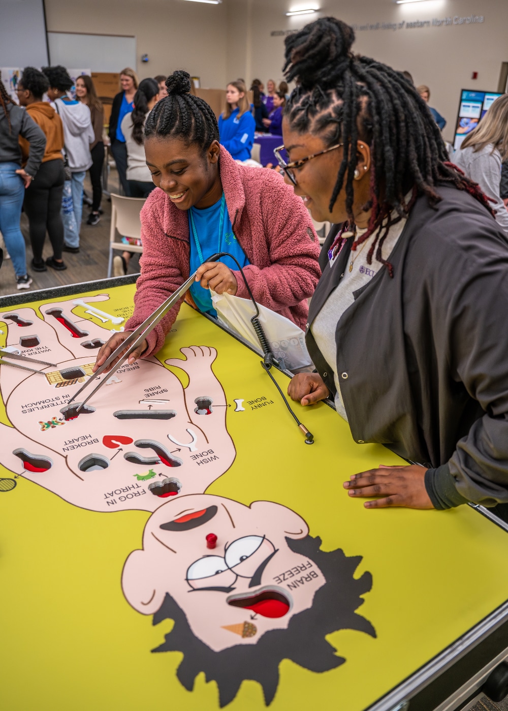 Health Sciences Academy students play a game of Operation during their career fair on March 5, 2023.