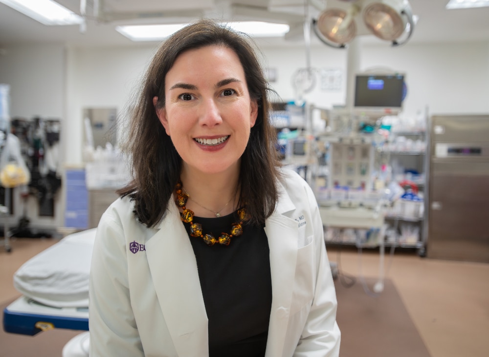 Dr. Leigh Patterson poses for a photo in a patient room in the Emergency Department at ECU Health Medical Center.