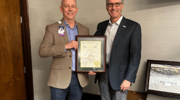 Jim Worden poses for a photo with ECU Health CEO Dr. Michael Waldrum after Worden received the Order of the Long Leaf Pine award.