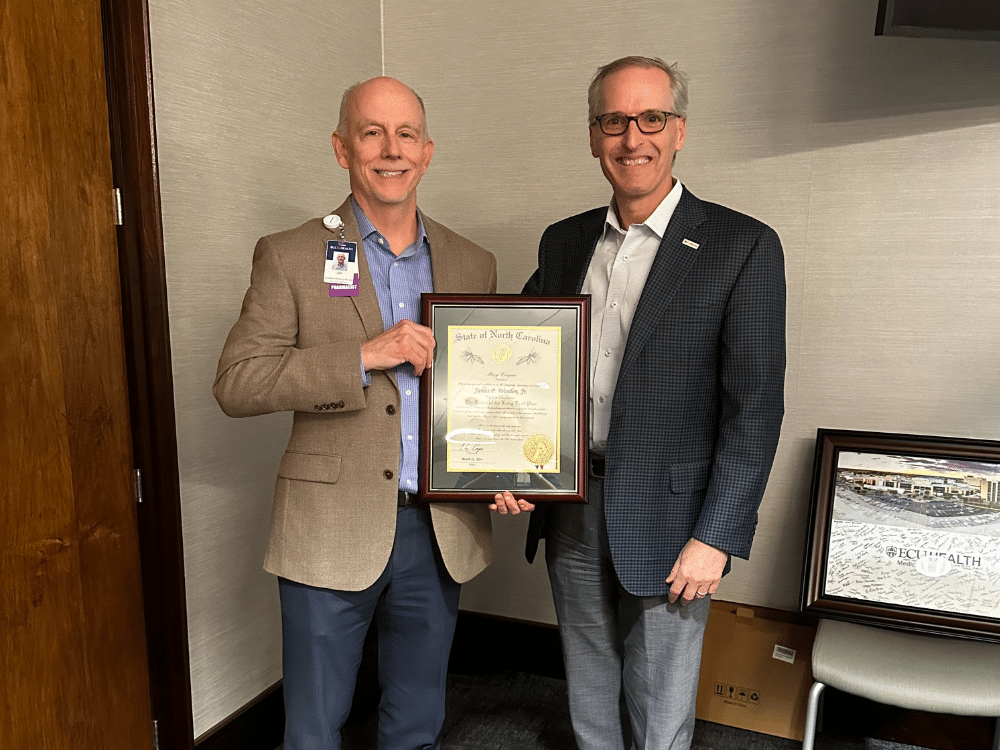 Jim Worden poses for a photo with ECU Health CEO Dr. Michael Waldrum after Worden received the Order of the Long Leaf Pine award.