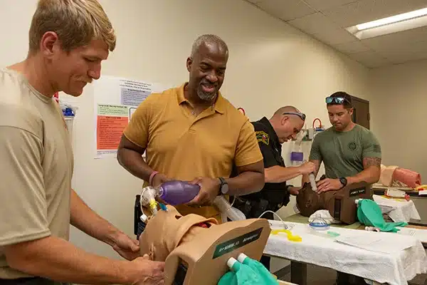 Current and retired North Carolina law enforcement and first responders practice airway management techniques at the Brody School of Medicine simulation center.