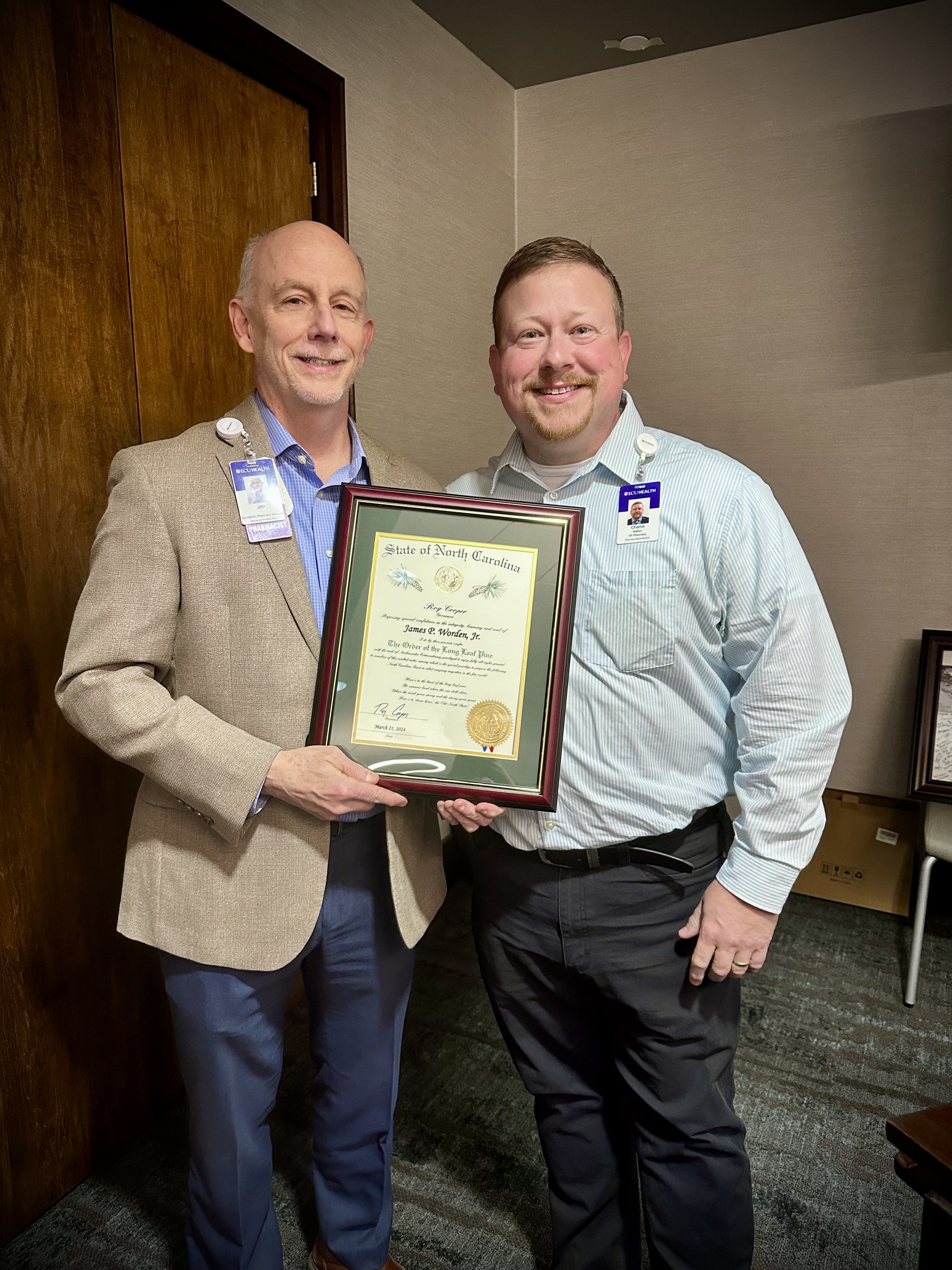 Jim Worden poses for a photo after he was awarded the Order of the Long Leaf Pine at his retirement party in March of 2024.