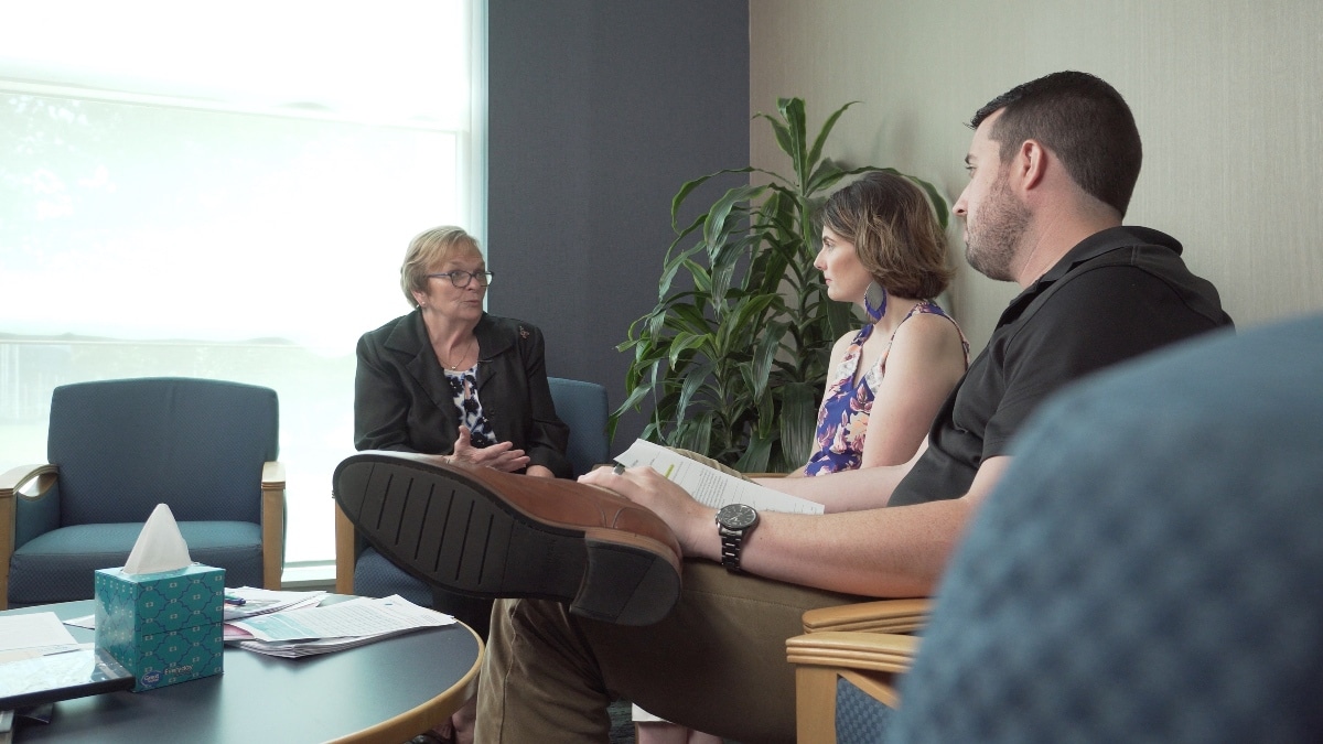 Two community members speak with a member of ECU Health's Advance Care Planning team.