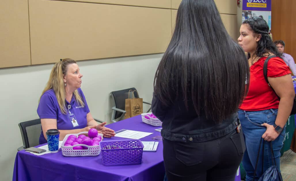 An ECU Health team member talks to local students about careers in health care.