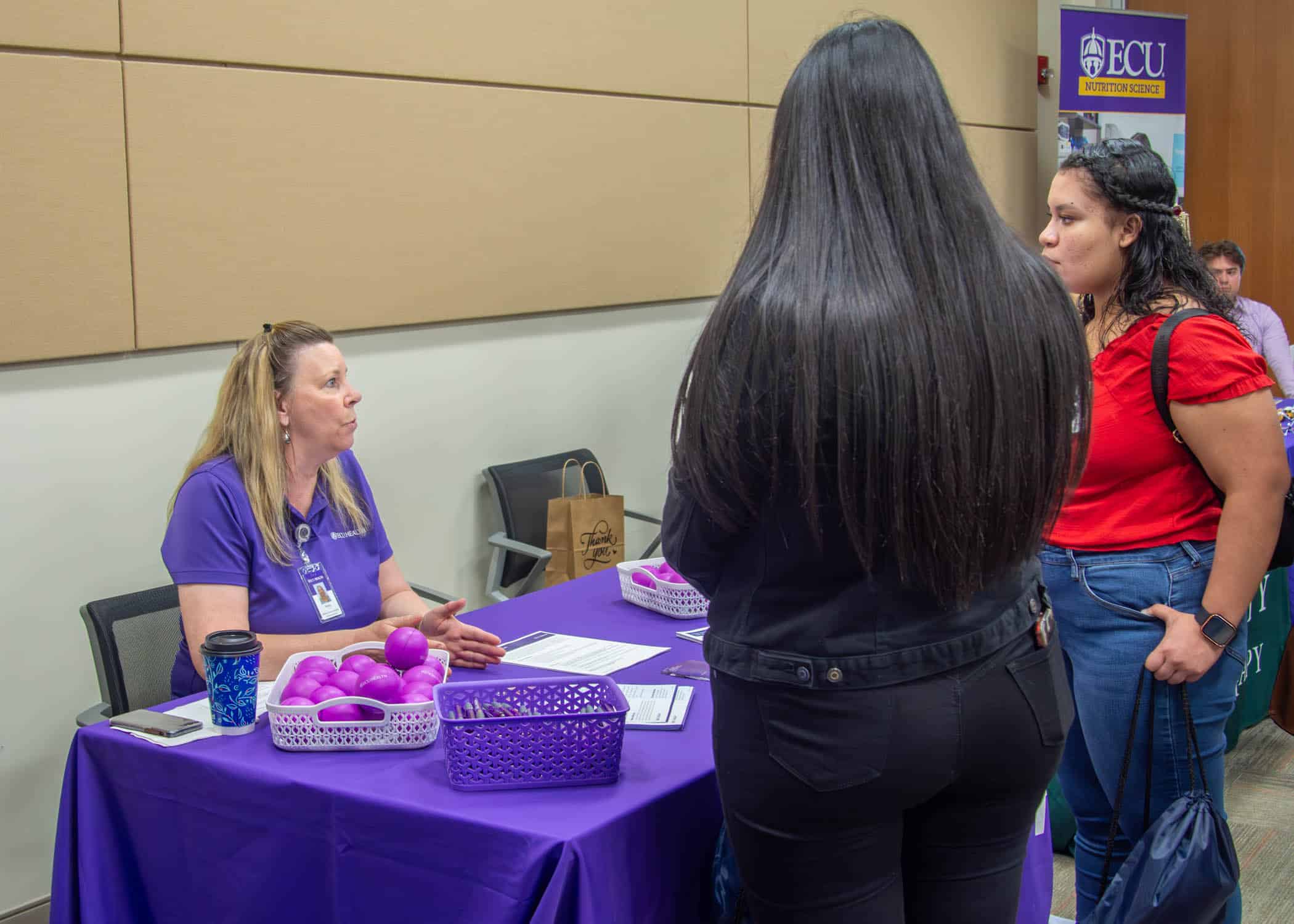 BrodySim-CareerFair-0214-Edit An ECU Health team member talks to local students about careers in health care.