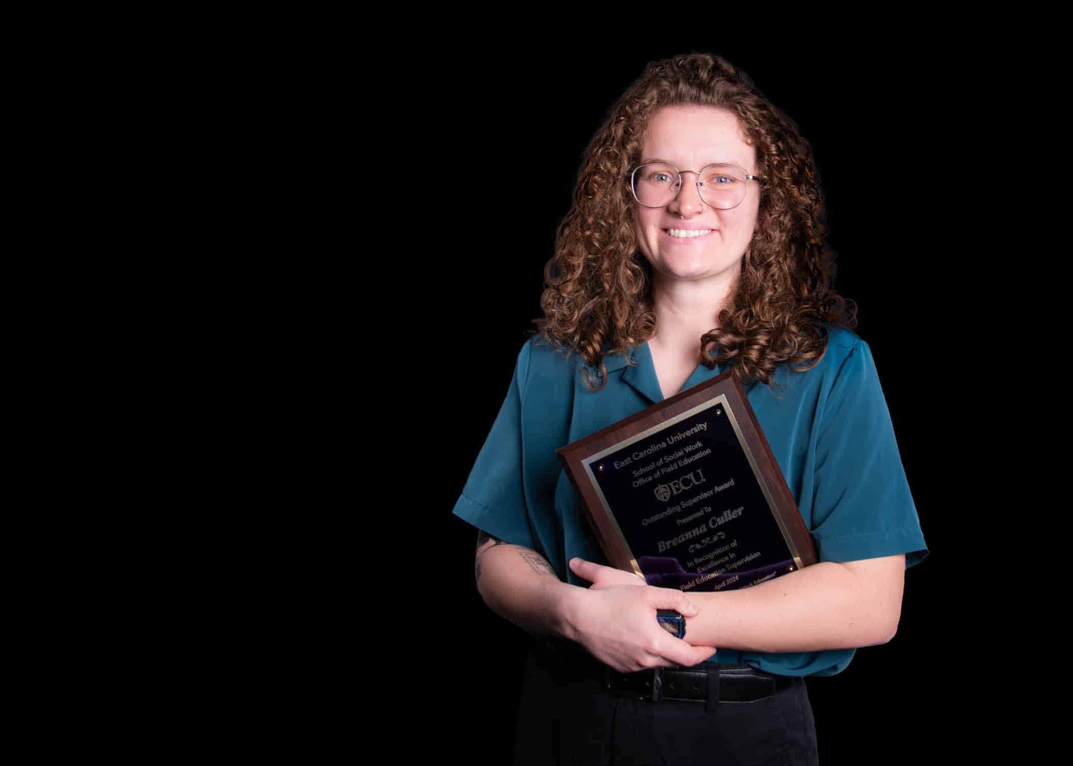 BreannaCullerAward-5681-Edit Breanna Culler poses for a photo with her ECU School of Social Work Outstanding Field Instructor award.
