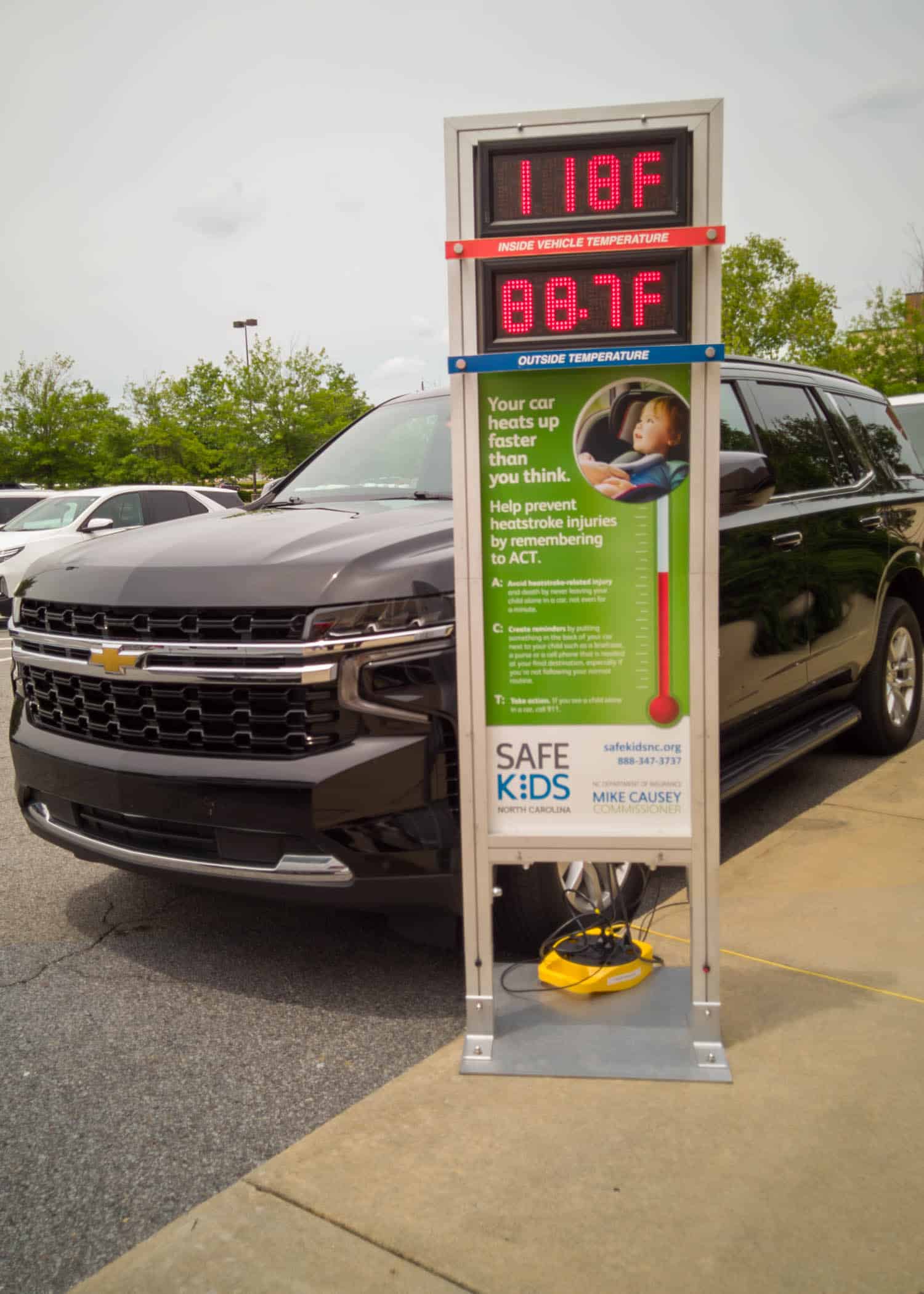 HotCarEvent2024-0937 Signage shows the interior of a car climbing to 118 degrees during an 88 degree day outside at a Hot Car Safety event in Greenville.