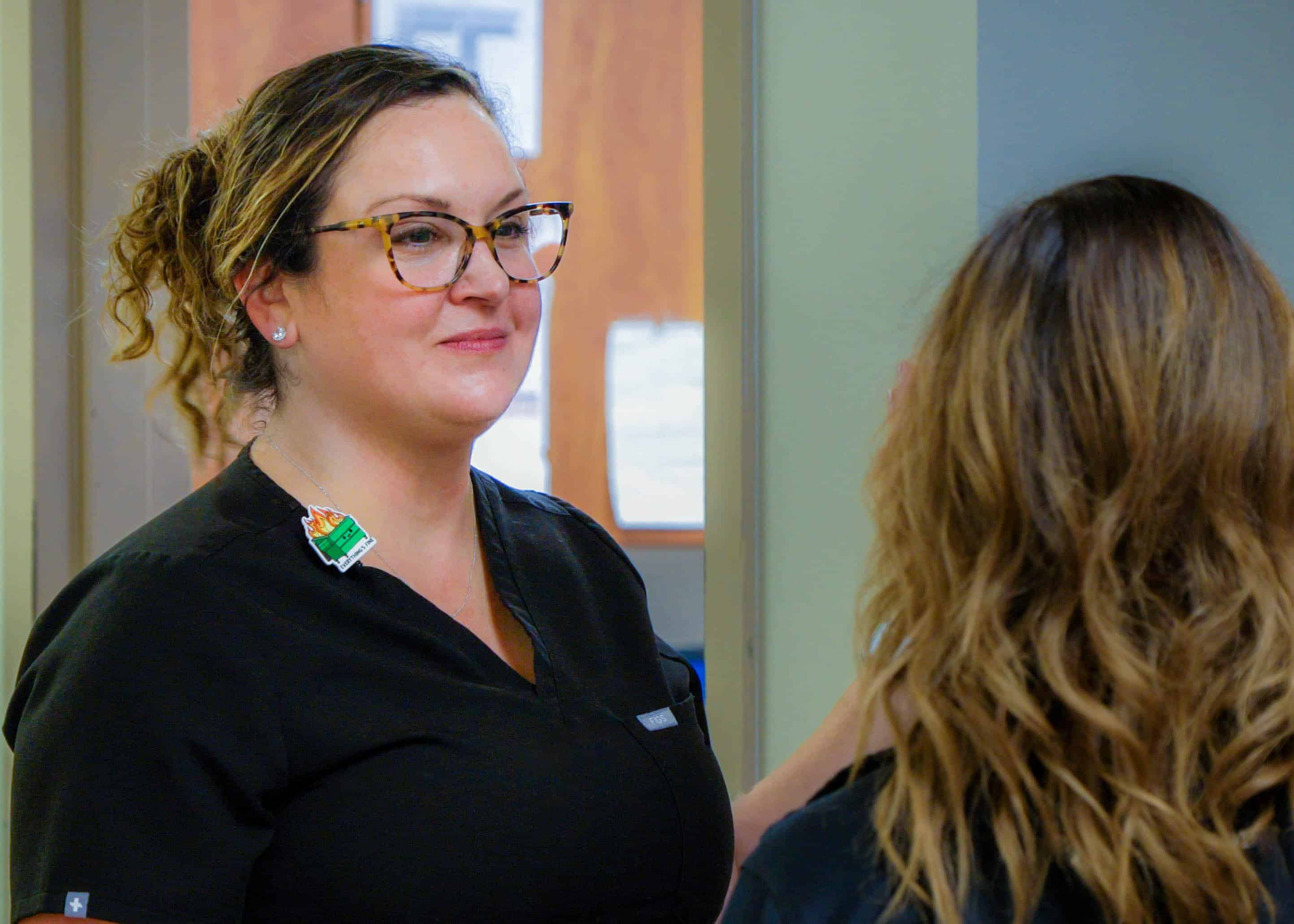 Suzanne Foster speaks with a fellow nurse at ECU Health Medical Center.