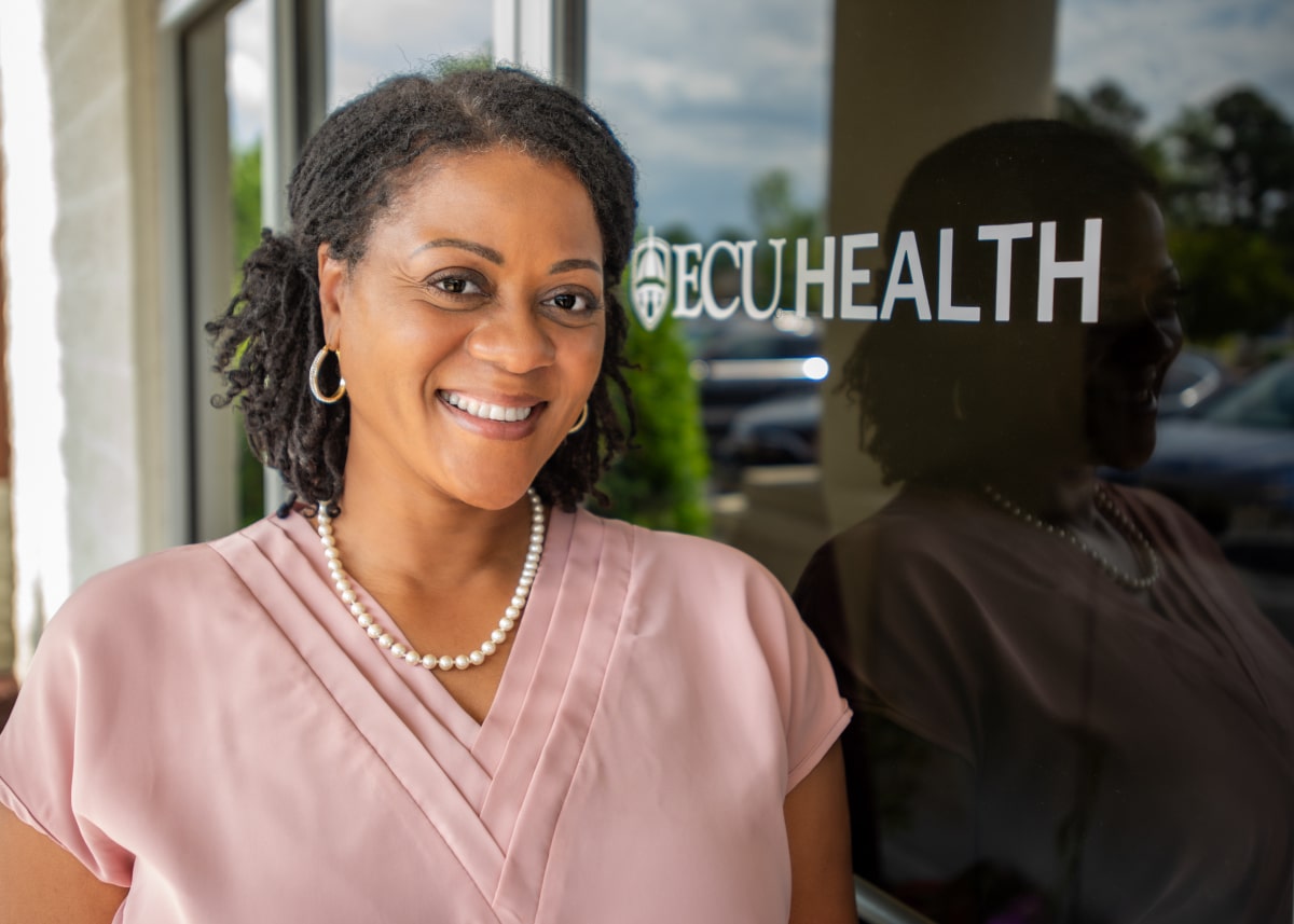 Cheryl Hooks poses for a photo outside of the Kenansville Family Medicine practice, where she sees her patients.