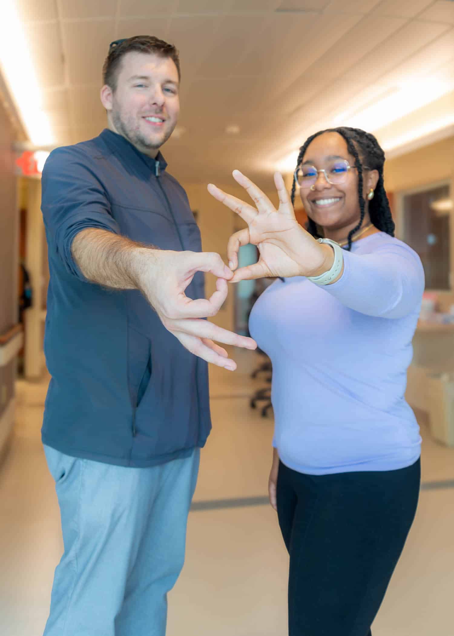 ASLInterpreters-8101-Edit Two ECU Health interpreters sign interpreter in American Sign Language.