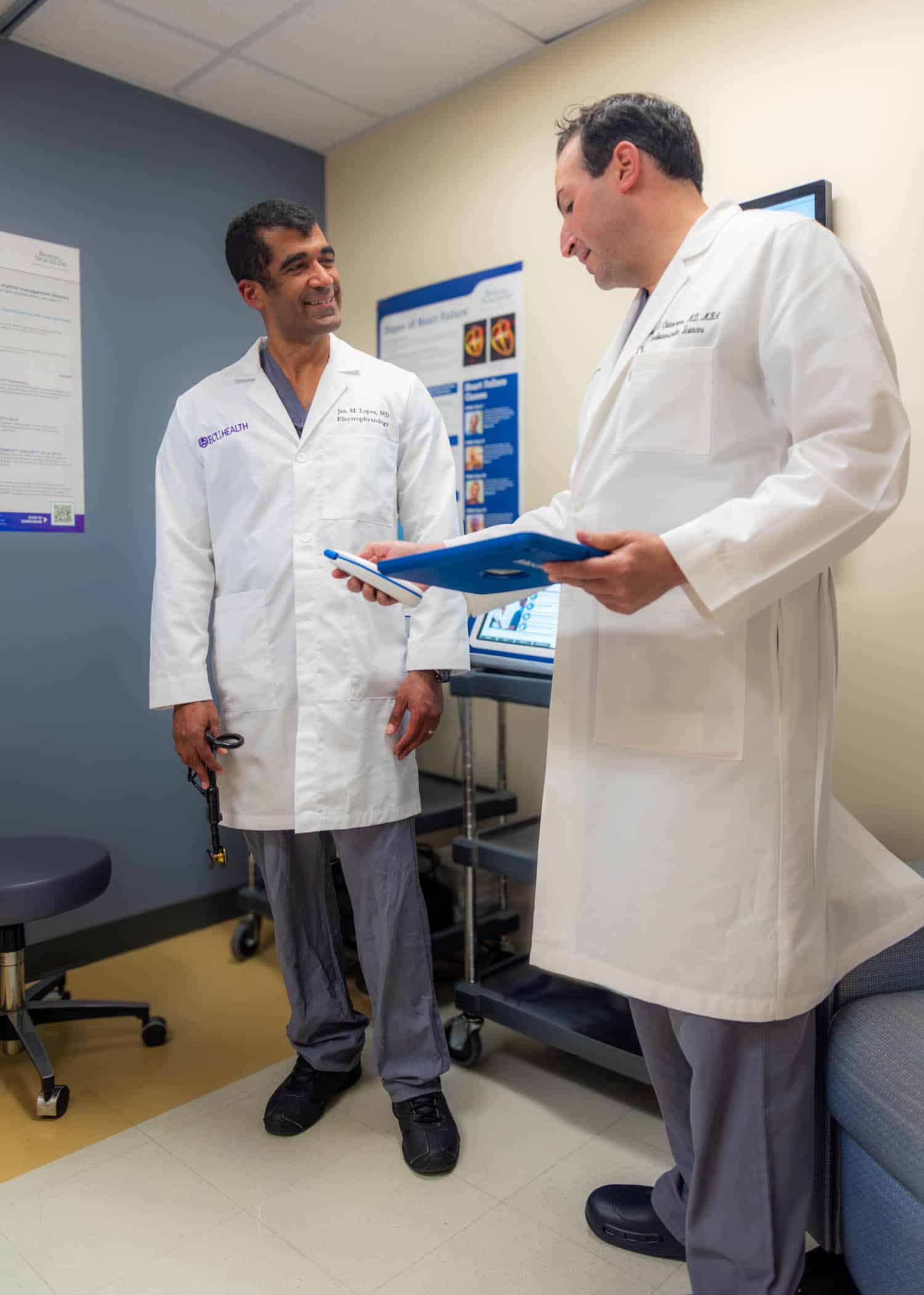 CatanzaroClinic-9250-Edit Dr. John Catanzaro speaks with a fellow physician to discuss patient care.