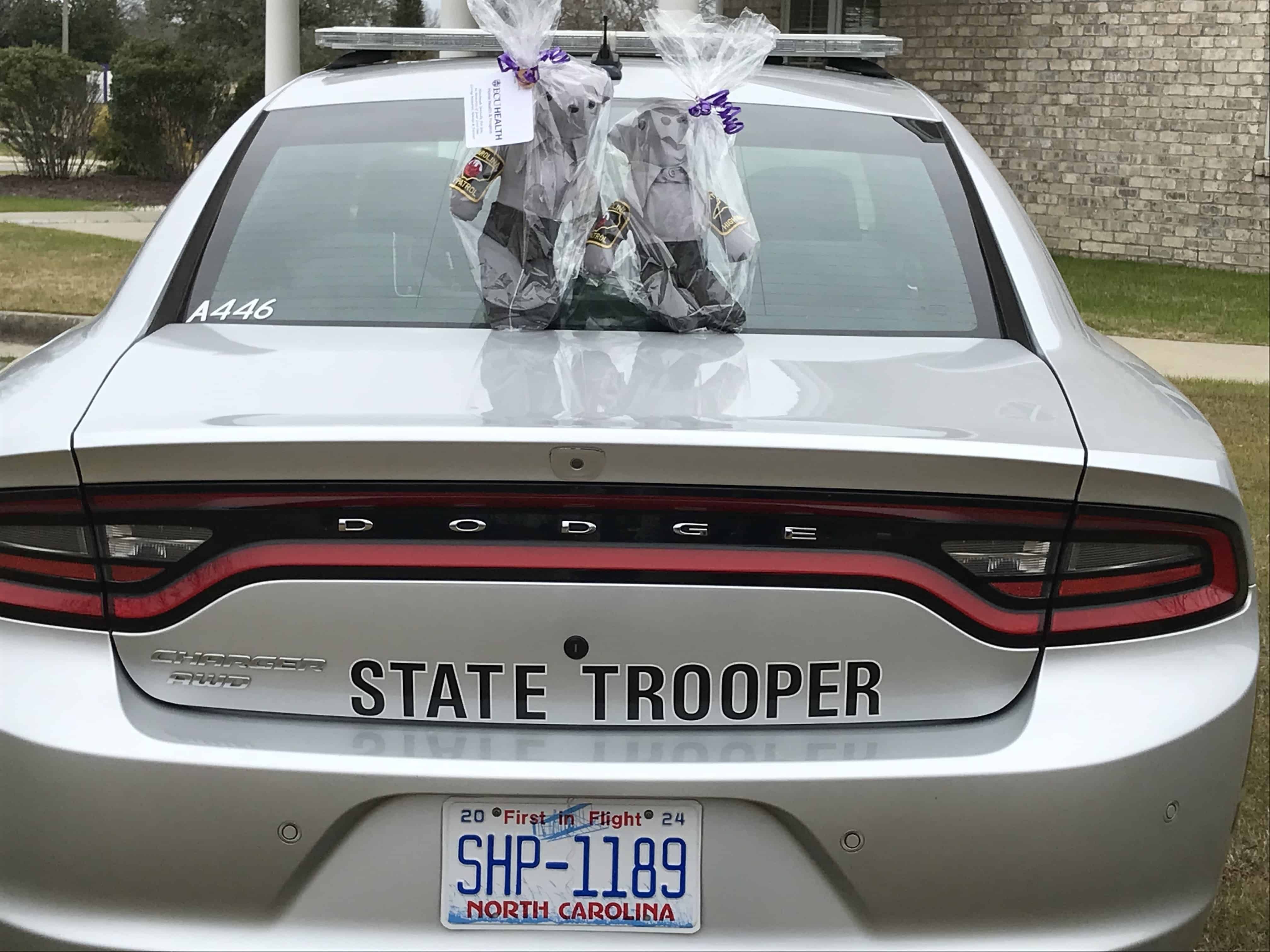 Memory bear on car Memory bears made at Service League of Greenville Inpatient Hospice, made for Zach Martin's family, sit on top of a North Carolina State Trooper vehicle.