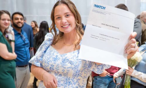 Sarah Waddell holds out her Match Day letter, showing that she matched at ECU Health Medical Center.
