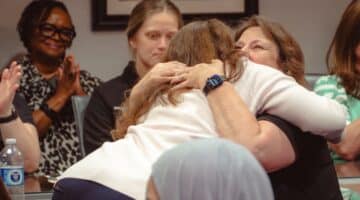 Two ECU Health team members share a hug after discussing their experience during Walk a Mile with Nursing.