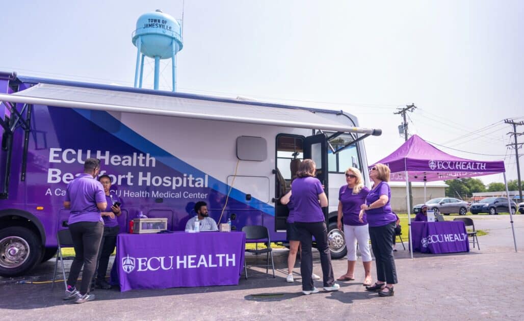 ECU Health team members gather with community members at a community health event in Martin County.