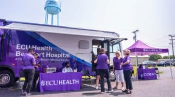 ECU Health team members gather with community members at a community health event in Martin County.