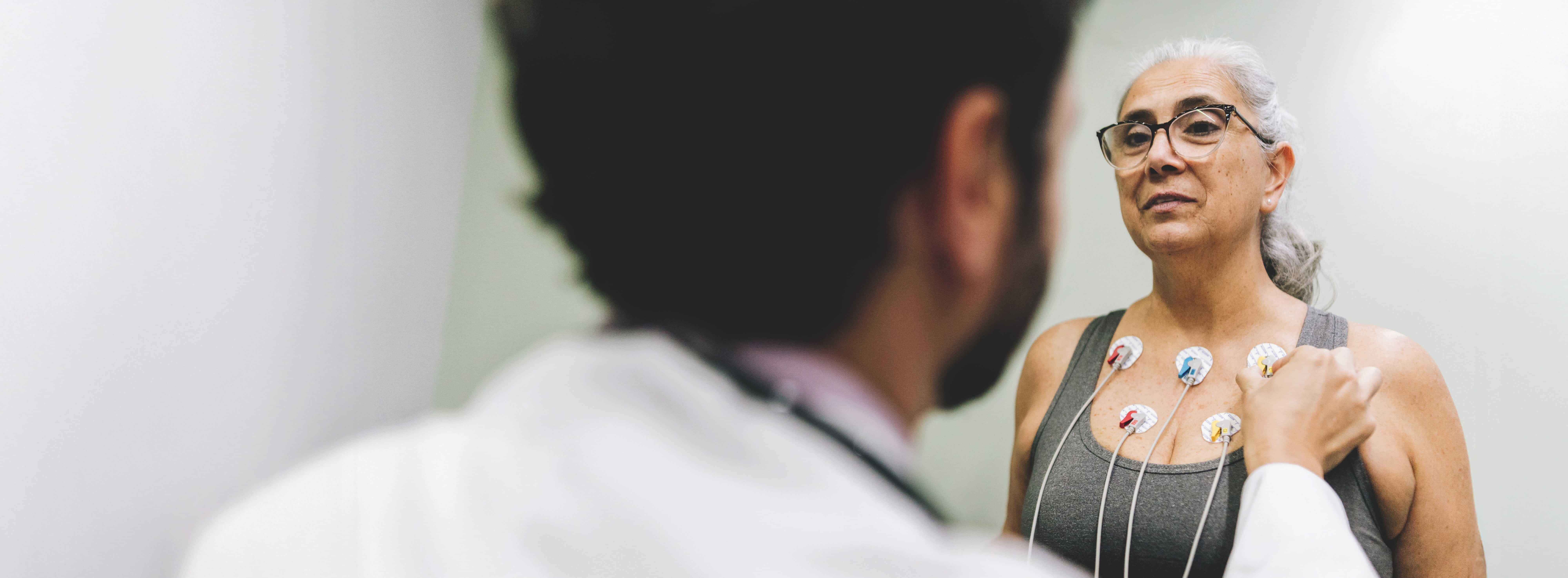 Patient talking with her doctor during a cardiopulmonary stress test on a hospital