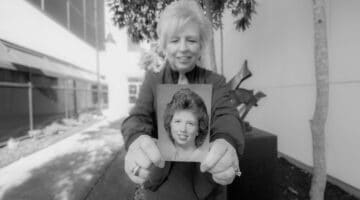 Karen Ward holds a photo of herself from the beginning of her career outside of ECU Health Medical Center.