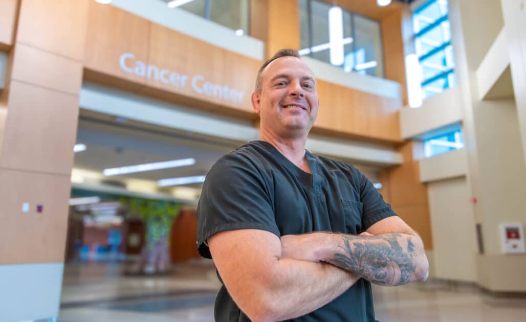 Tim Barnes poses for a photo in the cancer center at ECU Health Medical Center.