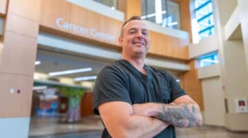 Tim Barnes poses for a photo in the cancer center at ECU Health Medical Center.