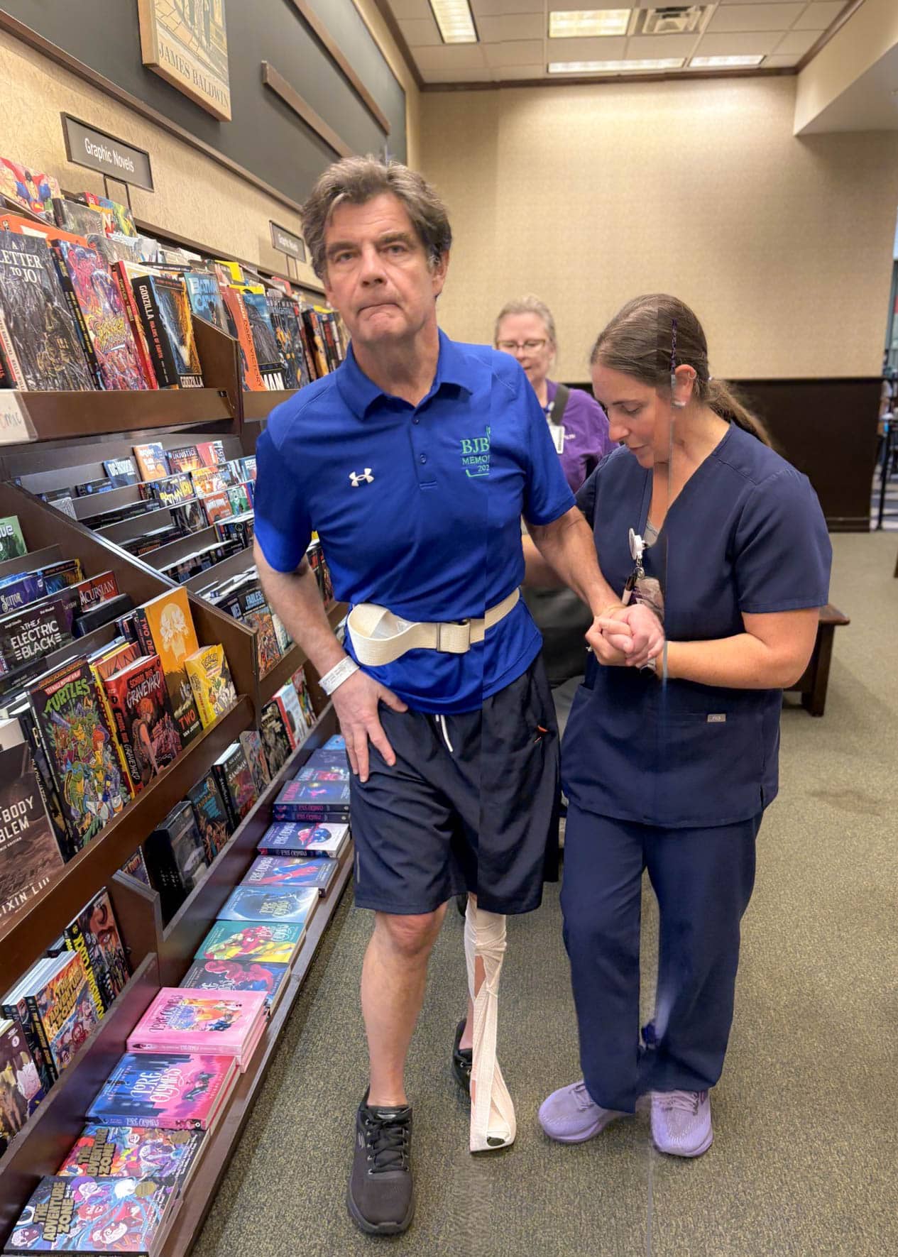 MarkBrady-5x7-2-Edit Mark Brady walks with an ECU Health team member during a rehabilitation visit to a store.