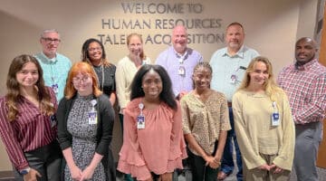 Non-clinical summer interns pose for a photo with program facilitators.